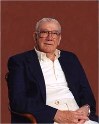 (Portrait of A.H. Nickless sitting in a chair looking at camera)