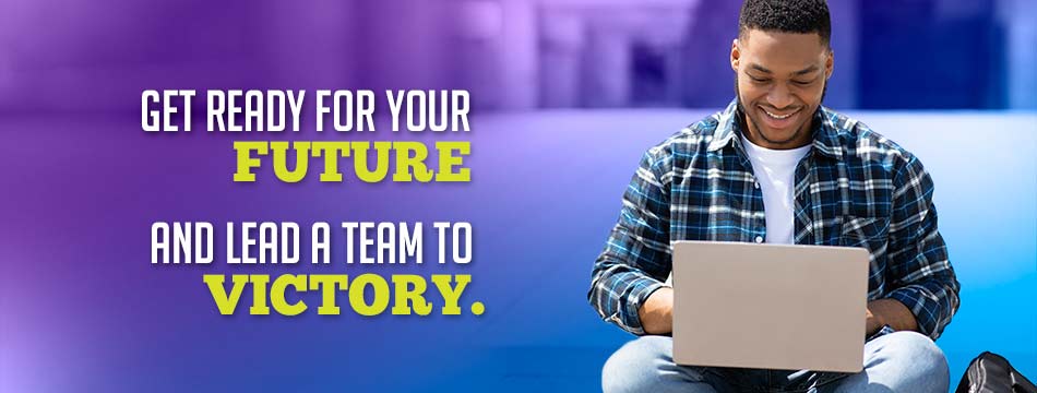 Get ready for your future, and lead a team to victory. (Smiling student using a laptop)